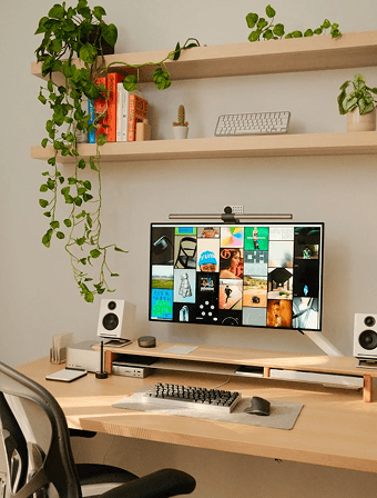 A studio desk with design work on screen