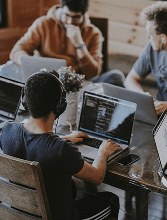 A software team working together on laptops